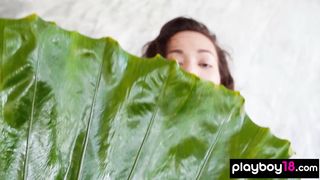 Petite small titted naked Filipino muse Kit Rysha posing with a huge leaf