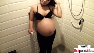 Big titted amateur Thai pregnant Pat taking a shower and giving handjob